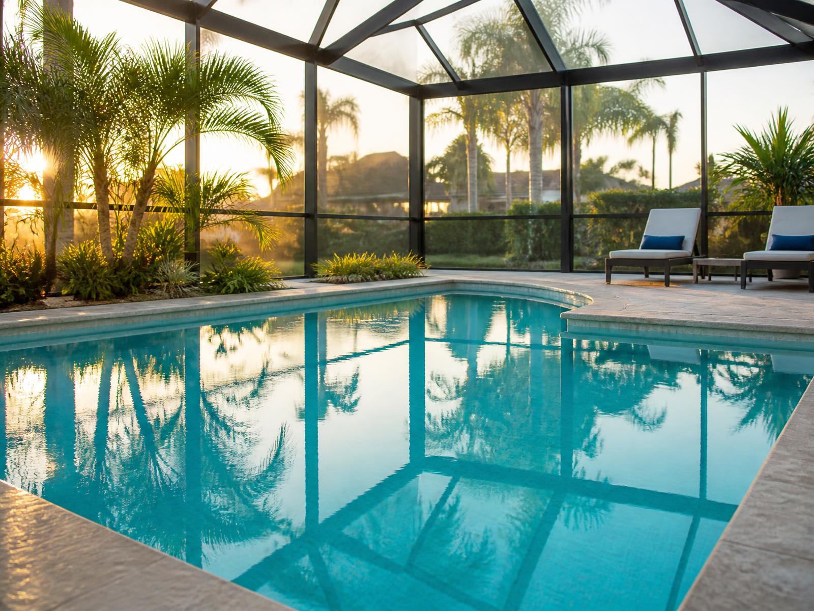 Crystal clear screened residential swimming pool in Tampa Bay at golden hour